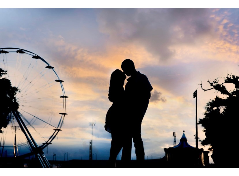 Ferris wheel silhouette at sunset