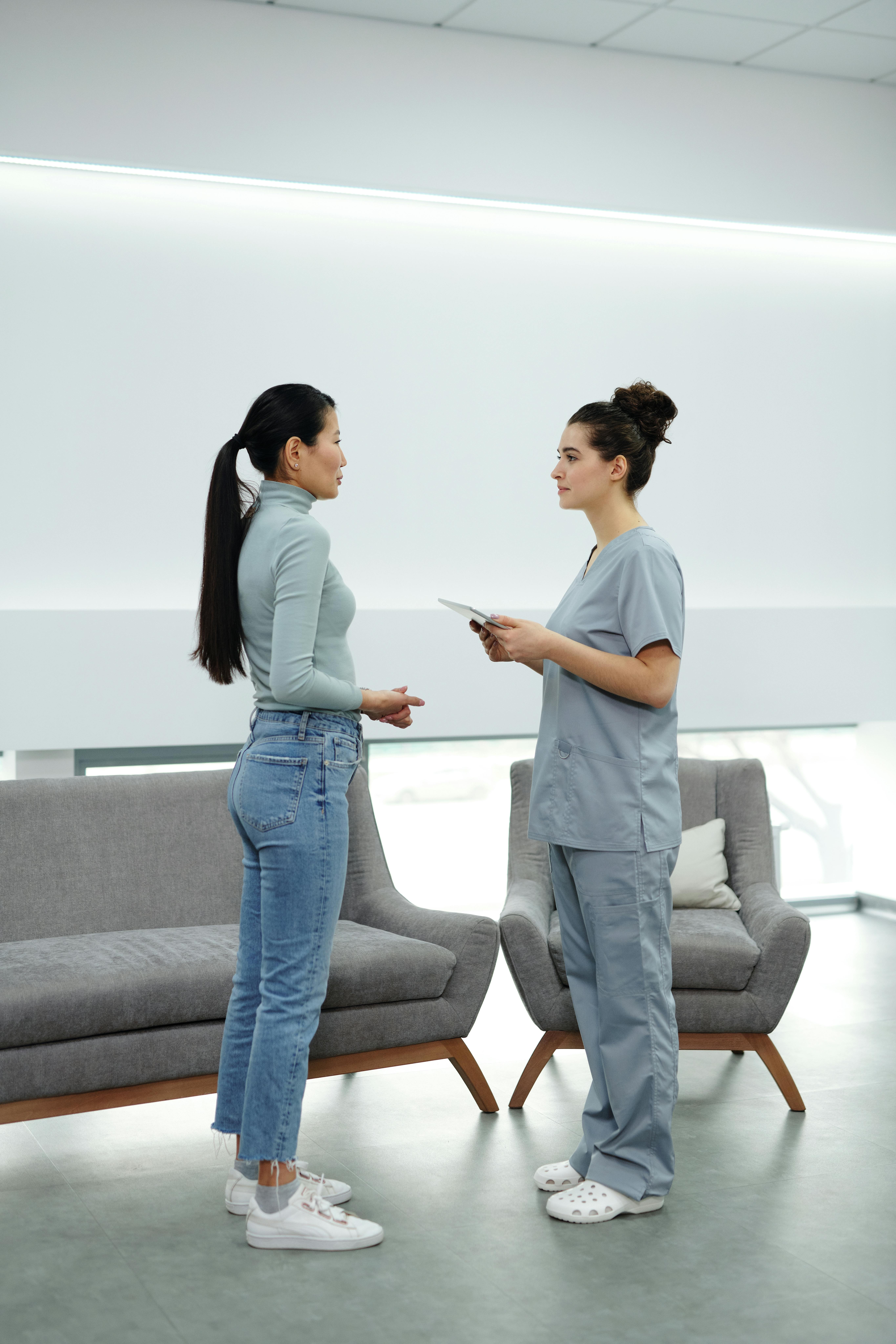 Patient talking with a medical professional in a clinical setting